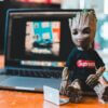 toy superhero near laptop on table at home